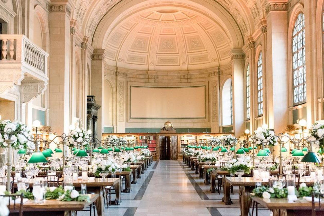 Boston wedding at the Boston public Library with library tables with green glass lanterns at each table | PartySlate