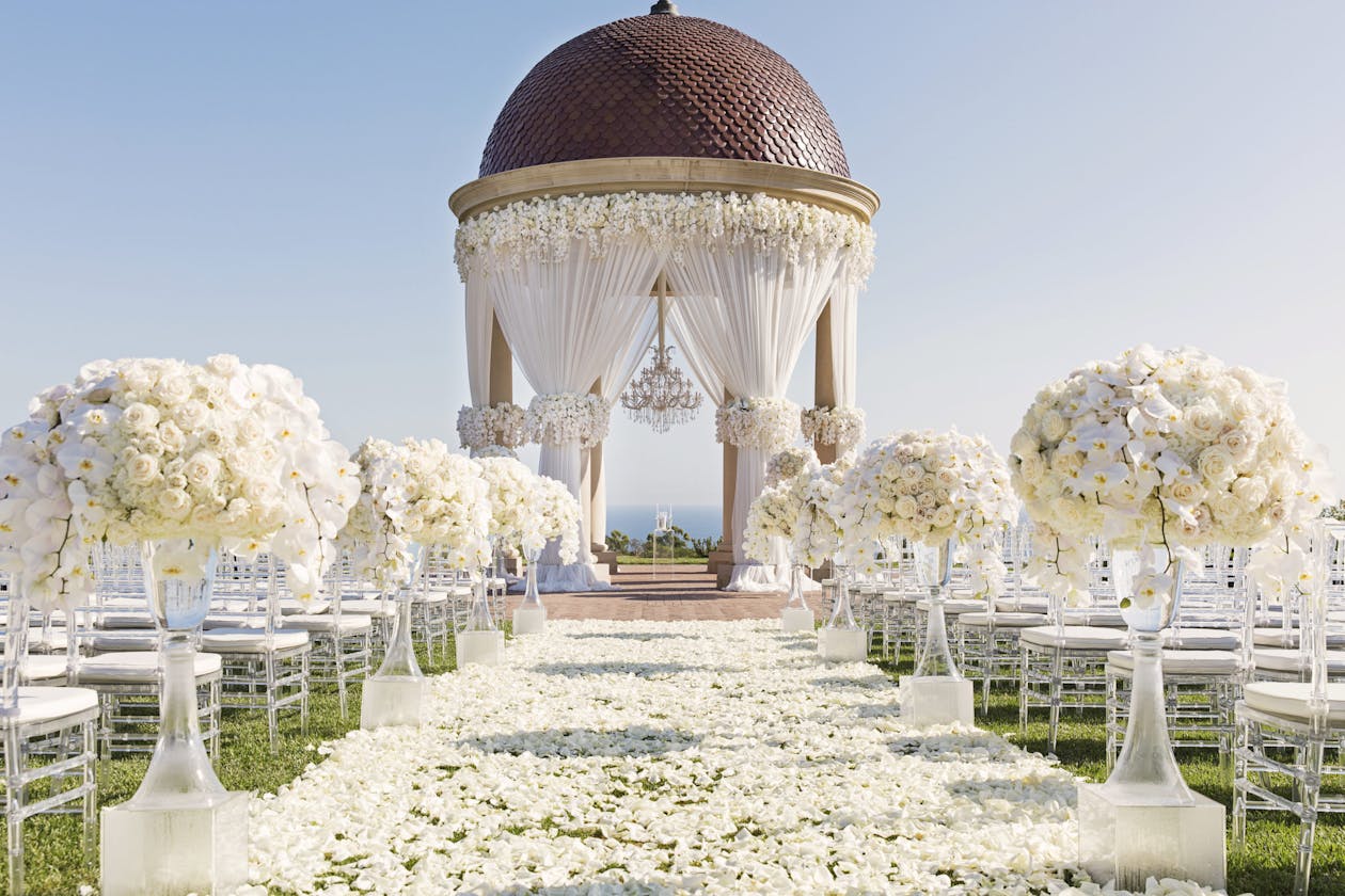 All white floral outdoor wedding ceremony at The Resort at Pelican Hill | PartySlate