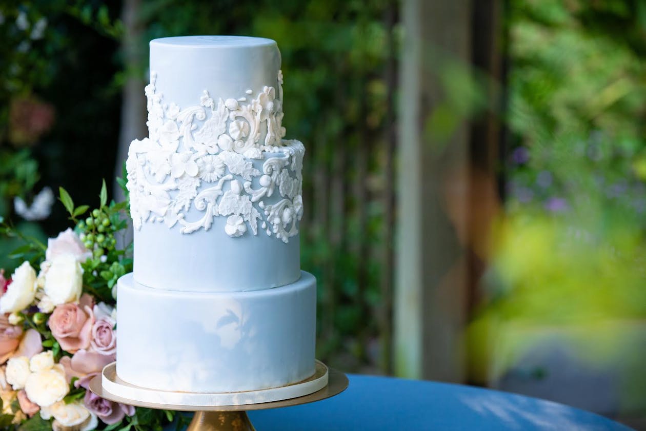 Blue wedding cake with lacy white frosting | PartySlate