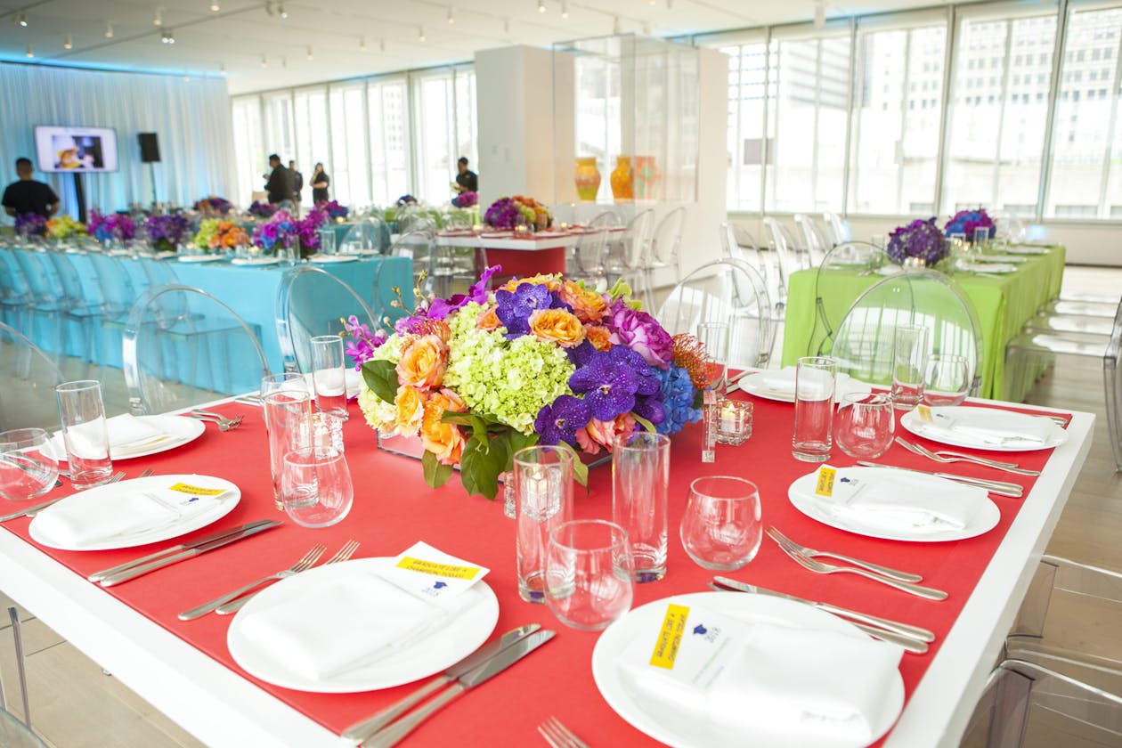 colorful floral centerpiece on a table for a graduation party | PartySlate