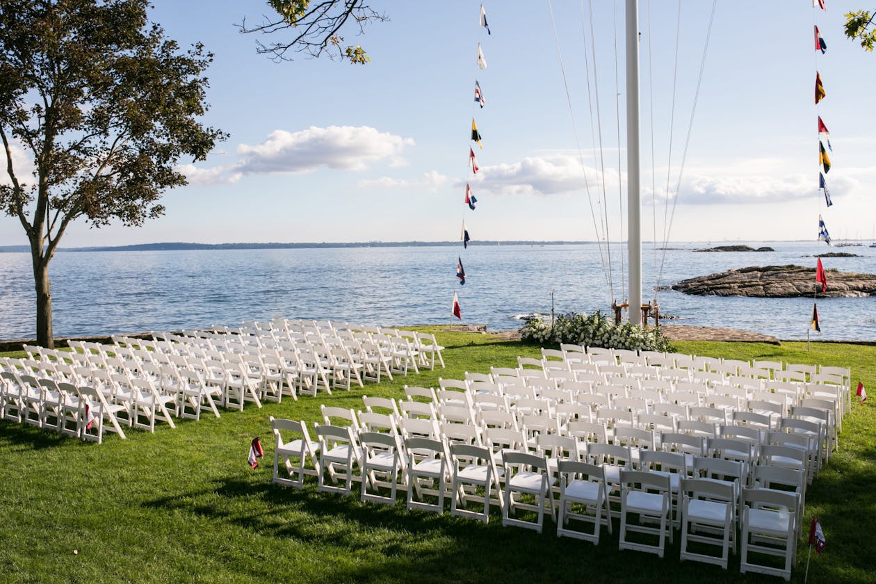 Seaside wedding with soaring mast ceremonial backdrop | PartySlate