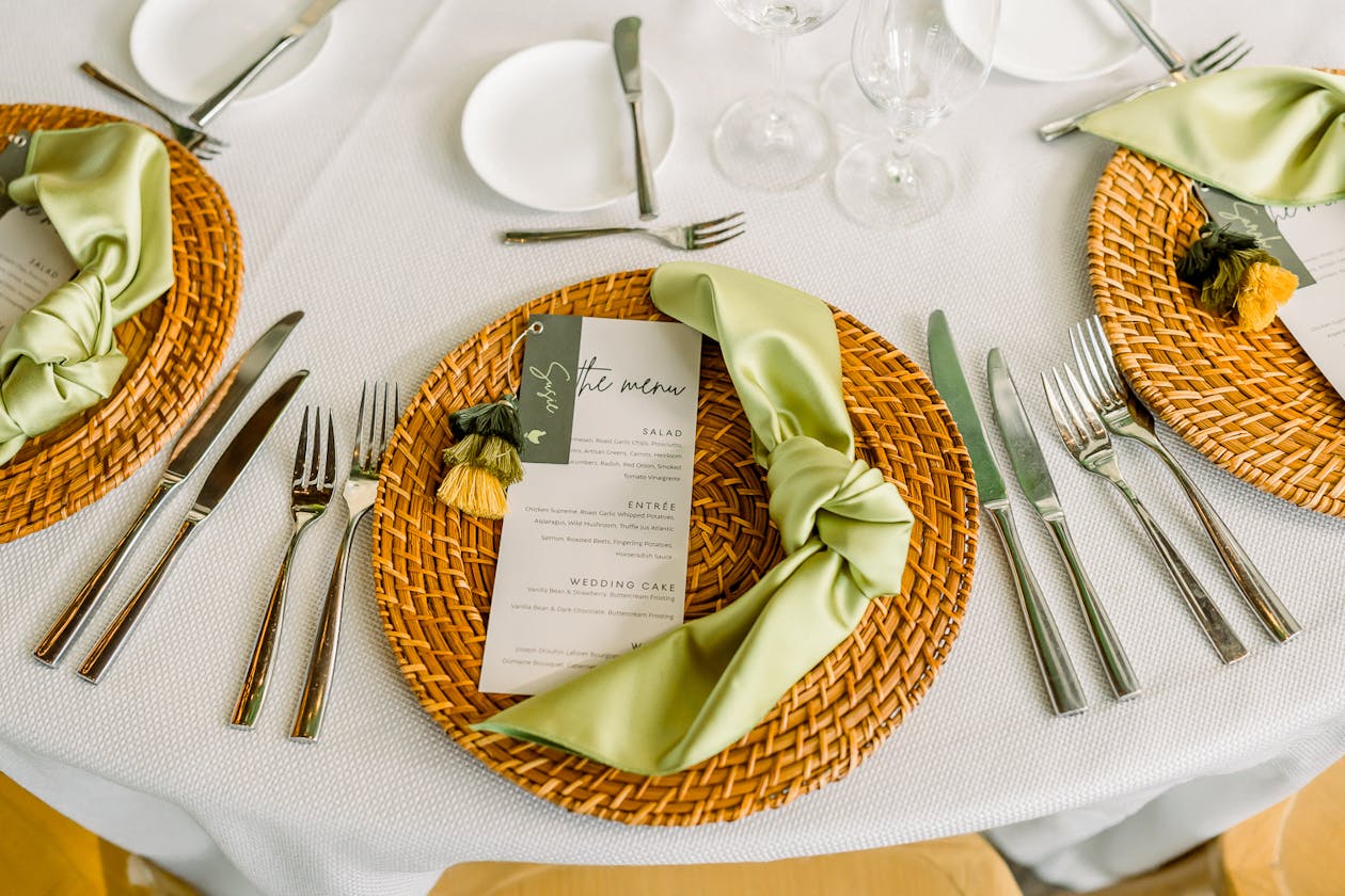 Wedding place setting with wicker plate charger and lime green napkin | PartySlate