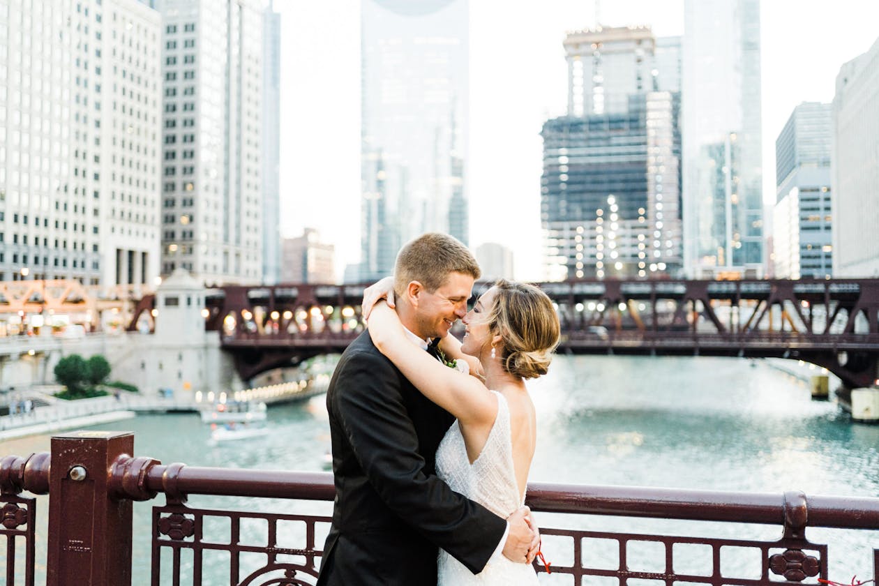 Outdoor wedding venues chicago wedding with teh skyline and river in the background with couple hugging each other | PartySlate