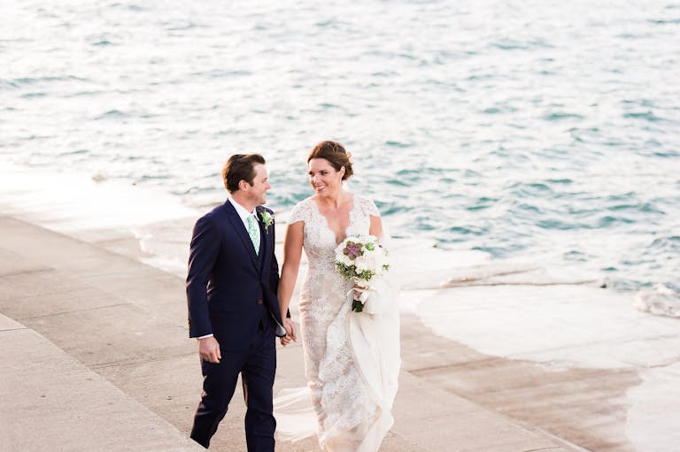 Couple walking outside by the river at Shedd Aquarium wedding | PartySlate
