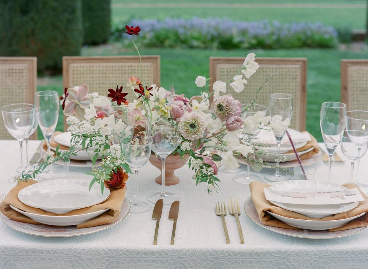 Flower centerpieces at rustic garden wedding | PartySlate