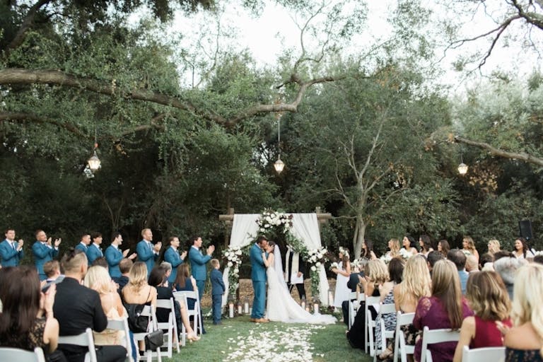 Outdoor white wedding ceremony at Temecula Creek Inn | PartySlate
