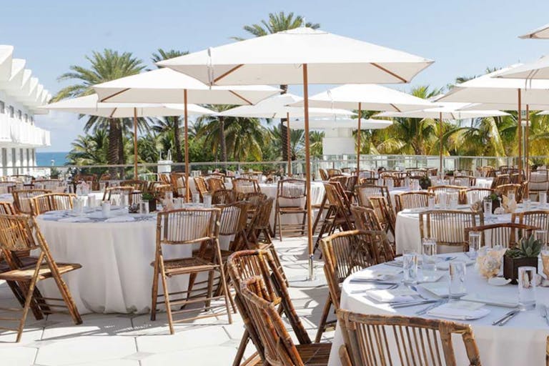 Shelborne South Beach rooftop terrace overlooking the ocean set up for a wedding reception | PartySlate