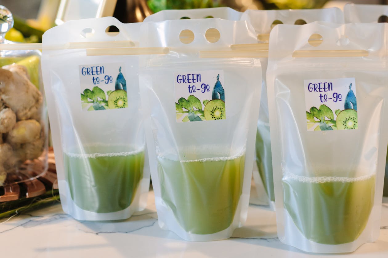 green juice in plastic to-go drink pouches | PartySlate