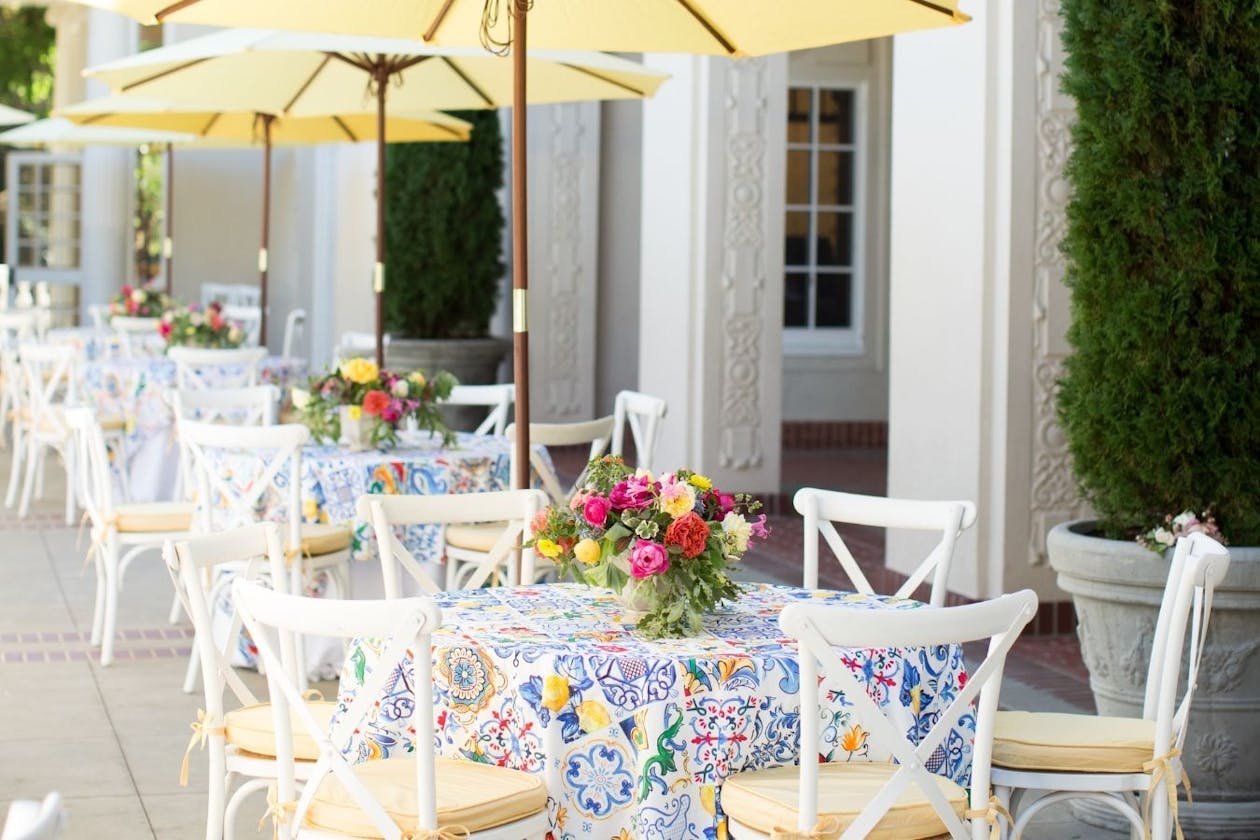 Outdoor baby shower with colorful table linen and bright table flowers | PartySlate