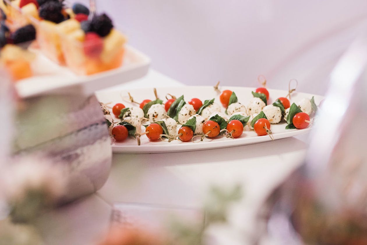 caprese salad bites on a toothpick at a baby shower | PartySlate