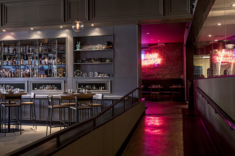 Double Zero restaurant in atlanta with pink neon sign behind bar area | PartySlate