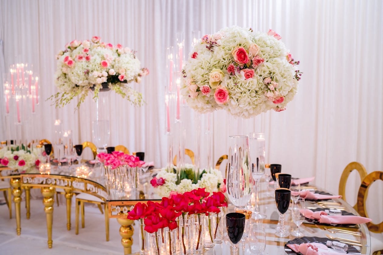 Mirrored tablescapes with gold modern seating and white and pink floral centerpieces | PartySlate