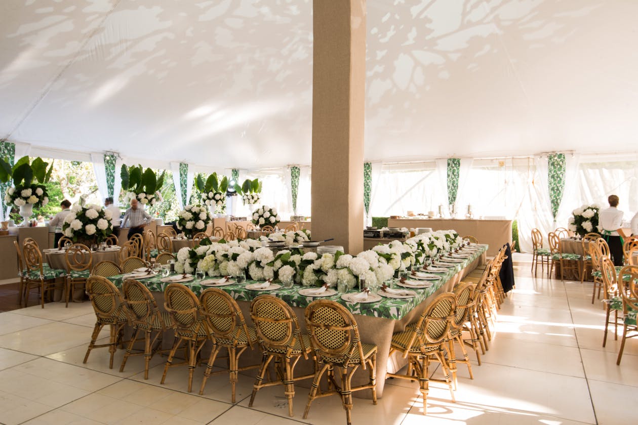 Tented baby shower with white florals and palm fronds | PartySlate