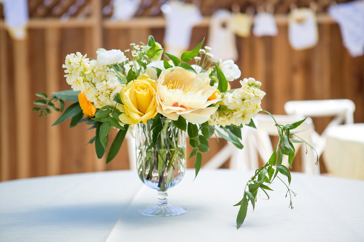 Spring centerpiece with yellow flowers for baby shower | PartySlate