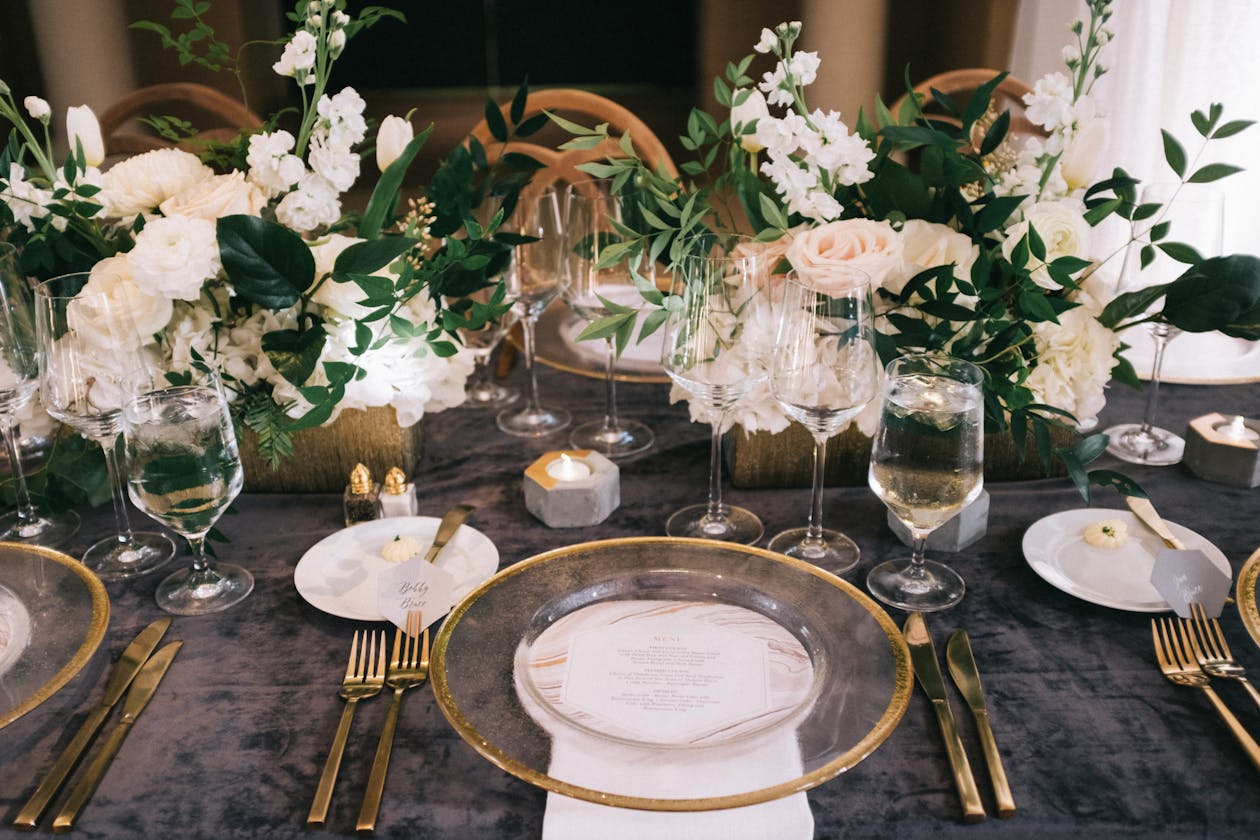 Romantic wedding table with white florals and gray crushed linen | PartySlate