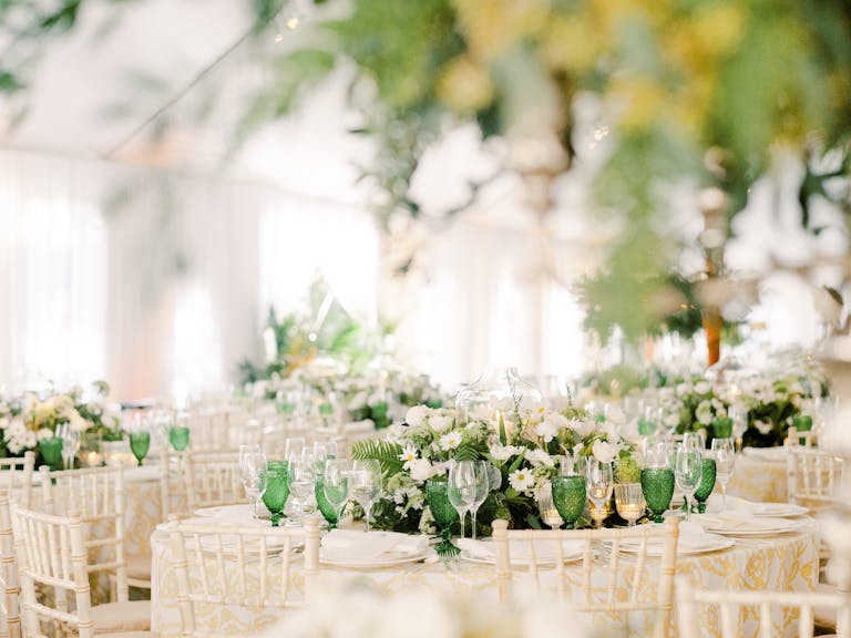 tented wedding with green centerpieces and green glassware | PartySlate