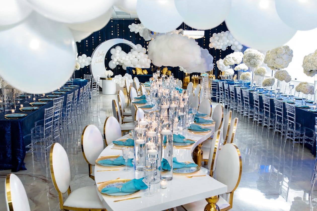 Celestial theme baby shower with curving table and white balloon ceiling | PartySlate
