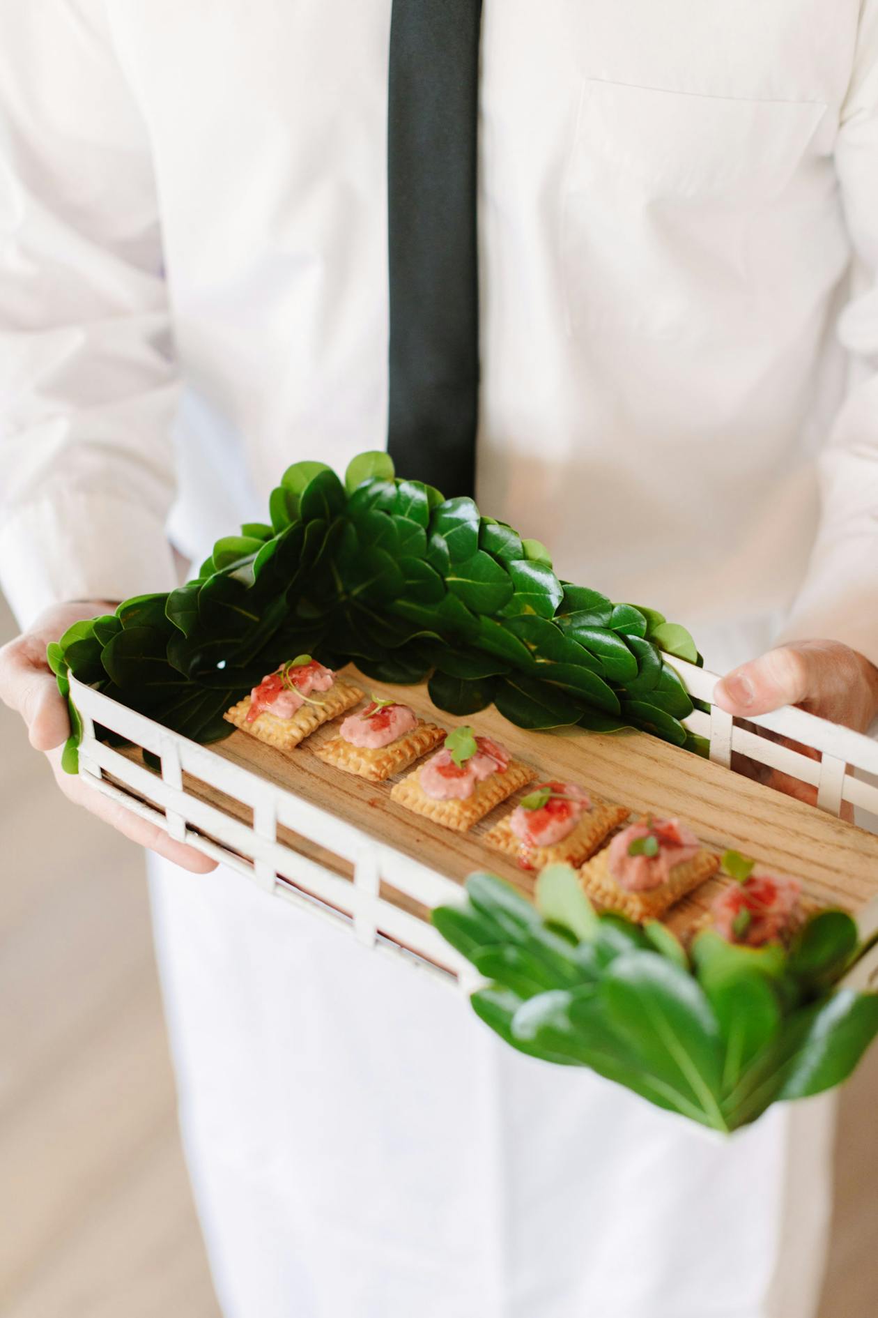 mini pop tarts displayed on a serving tray with greenery around | PartySlate