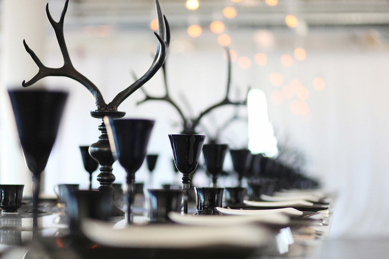 Modern wedding table with black goblets and antler décor | PartySlate