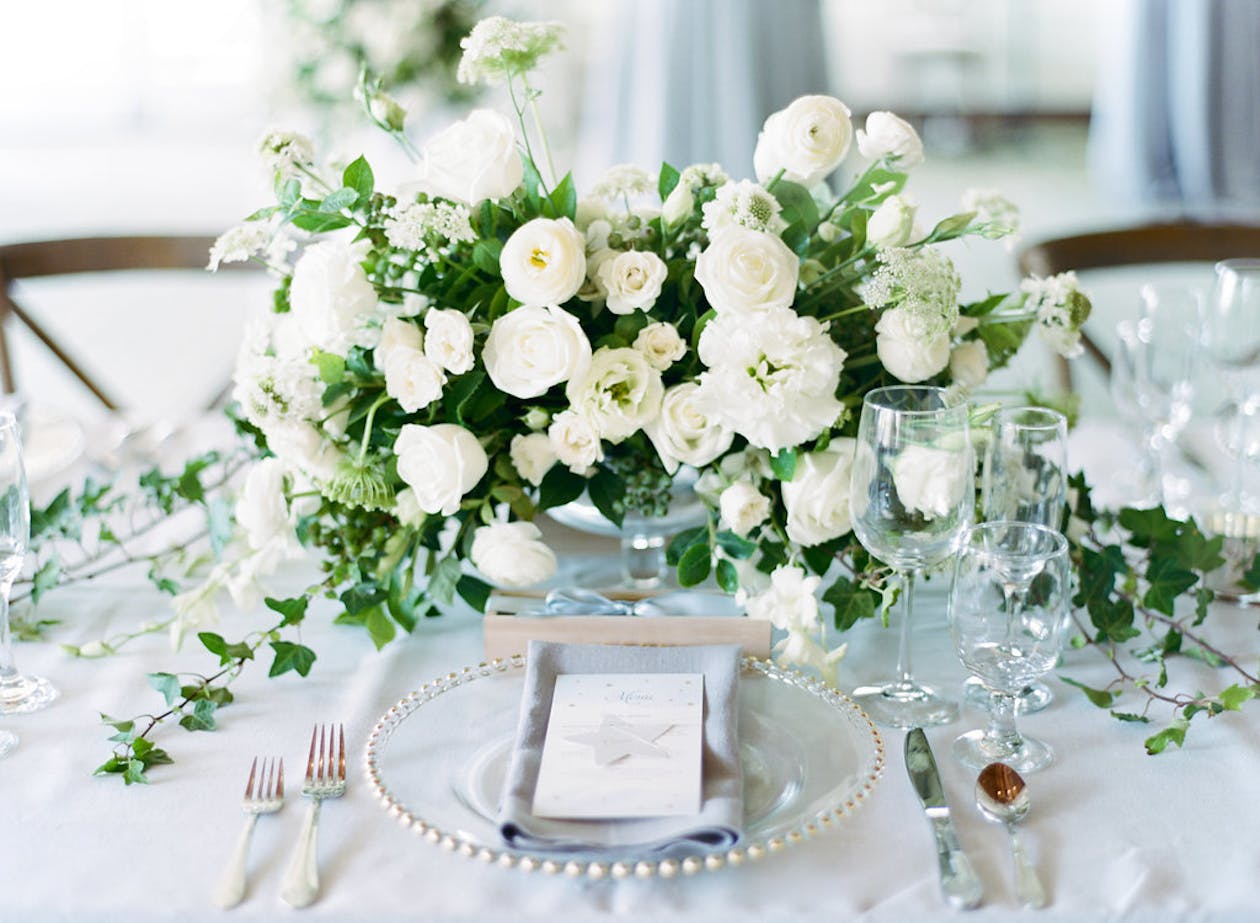 White floral centerpiece with greenery | PartySlate