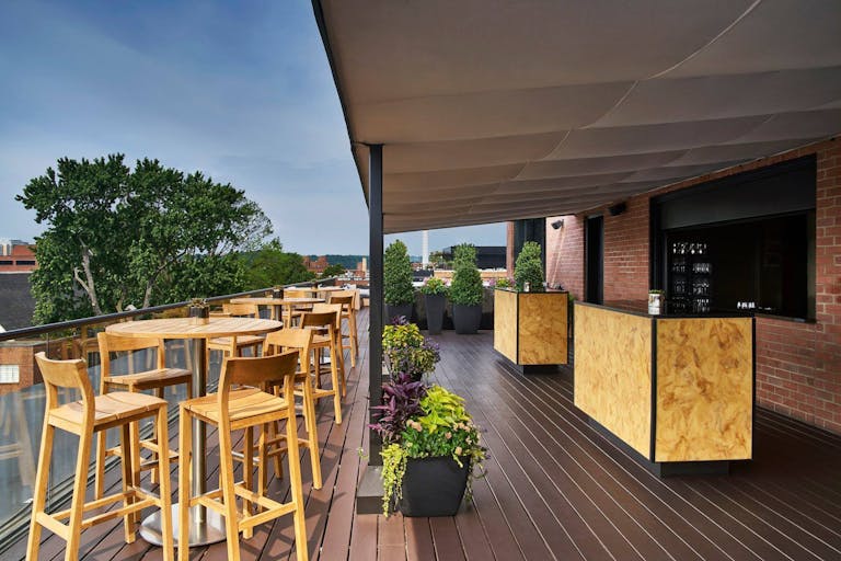 CUT D.C. at Rosewood Washington, D.C. rooftop with high tables and a bar | PartySlate