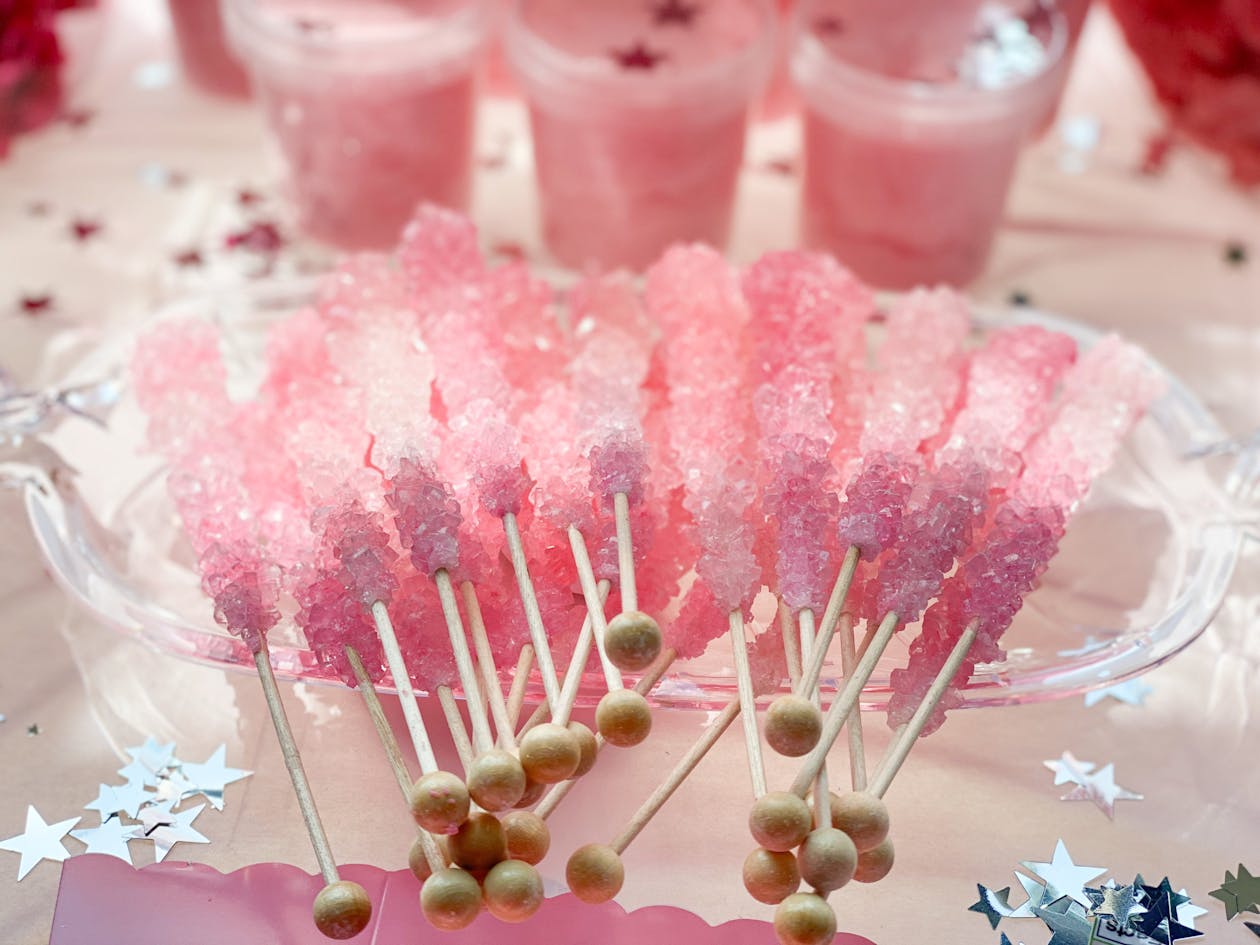 pink sugar rock candies on a stick | PartySlate