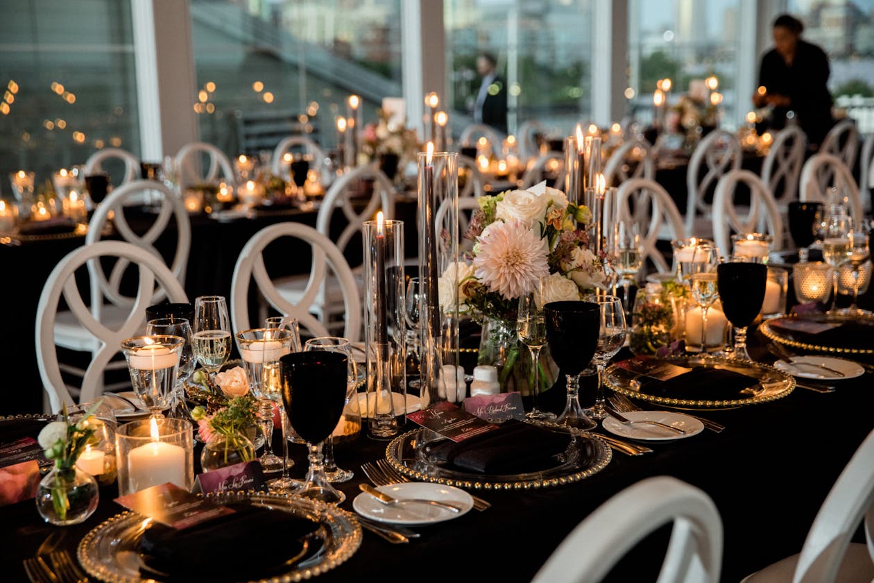 Moody industrial wedding with black tableware and candle light | PartySlate