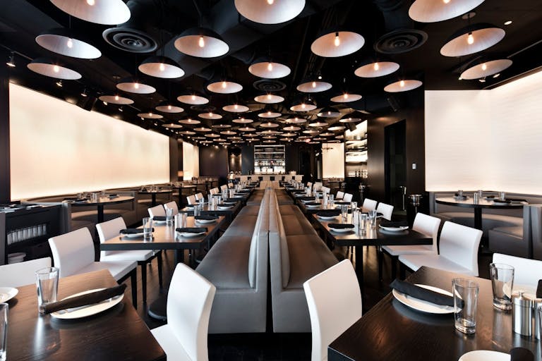 restaurant main dining room with silver, black, and white décor and sleek accents | PartySlate