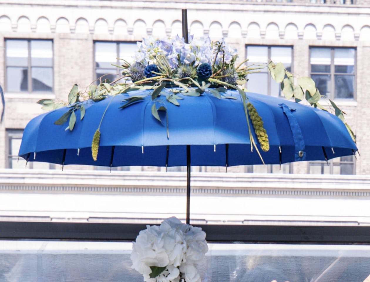Blue umbrella centerpiece with flowers | Partyslate