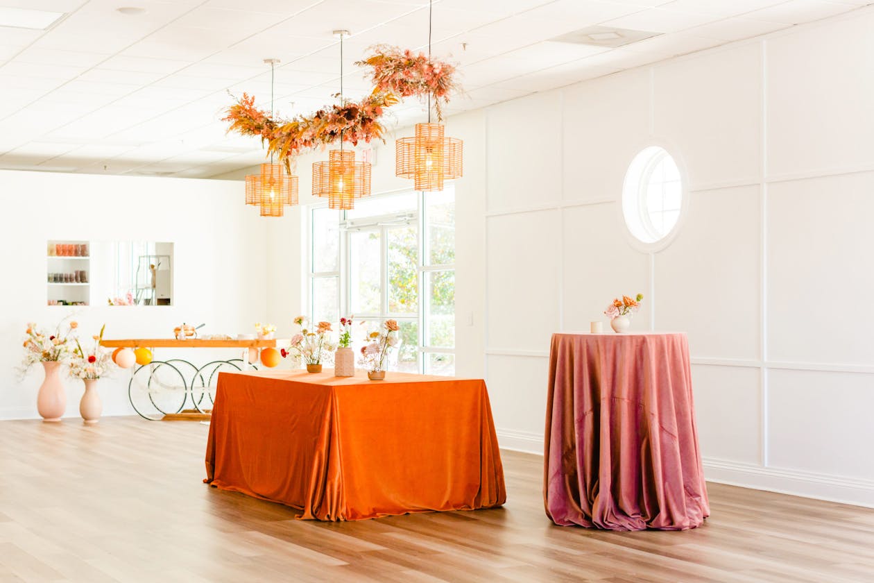 Boho baby shower with orange and mauve table line and suspended florals | PartySlate