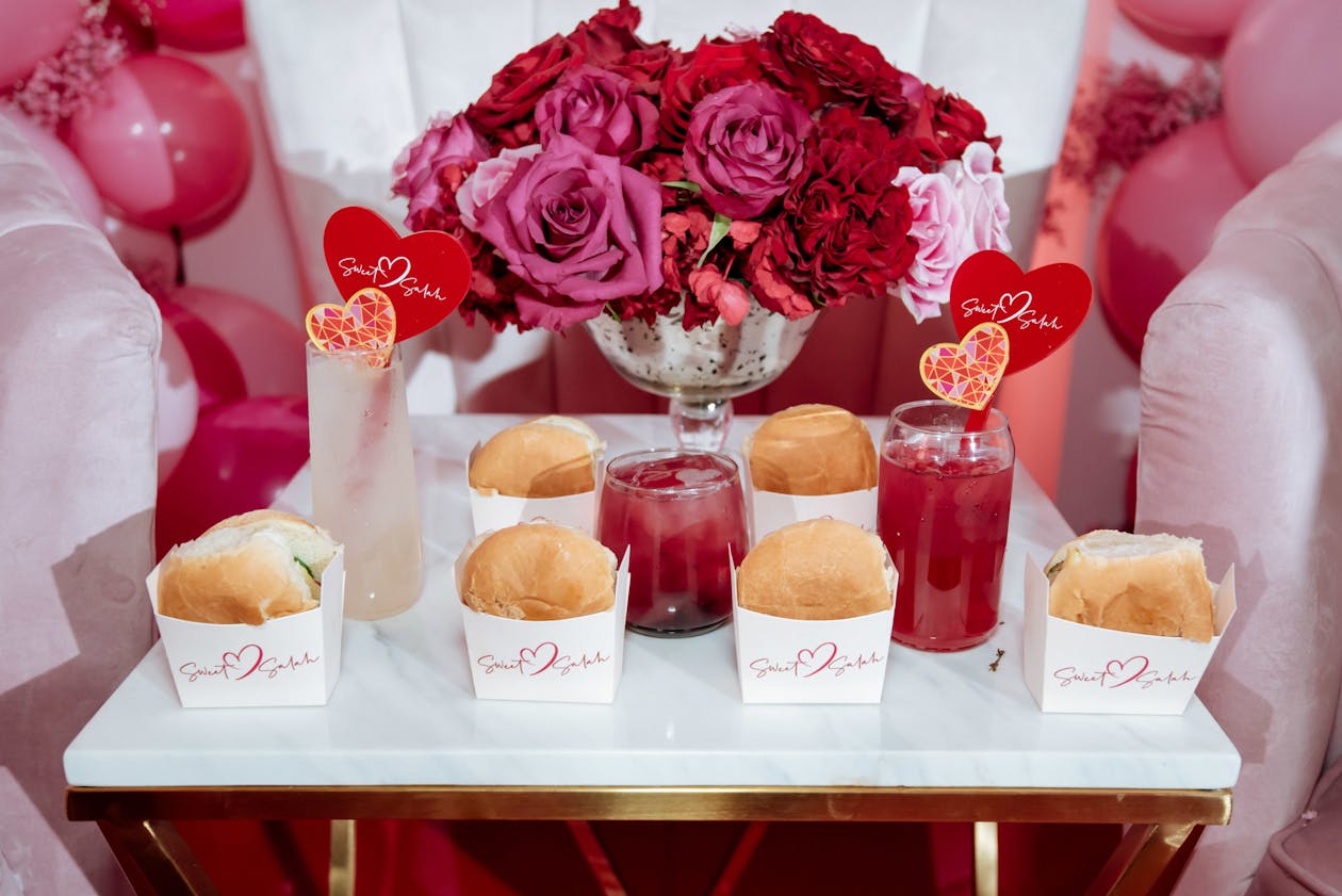 mini cheeseburgers on a platter with pink and red roses | PartySlate