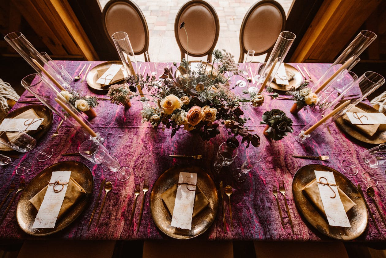 Moody wedding tablescape with crushed purple linen | PartySlate