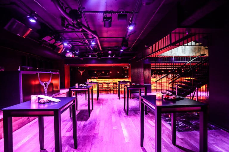Toro Toro, Washington DC downstairs private dining room with pink neon lights and high tables | PartySlate