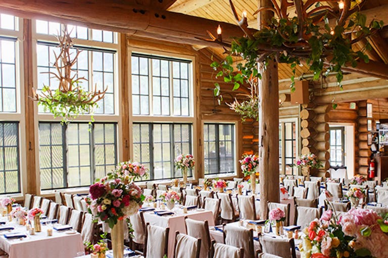 Beano's Cabin wedding reception with rustic architecture and pink linen and florals on tables | PartySlate