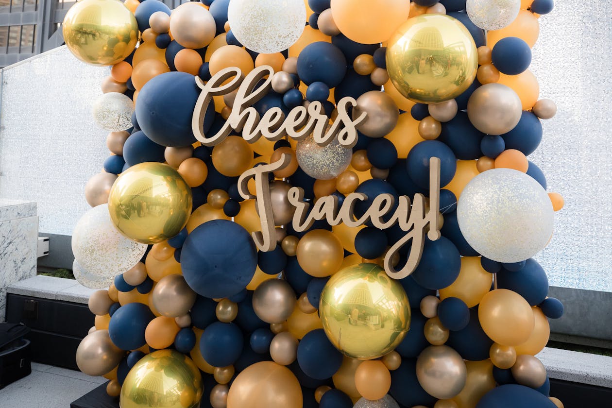 blue gold and white balloon backdrop with 60th birthday party signage | PartySlate