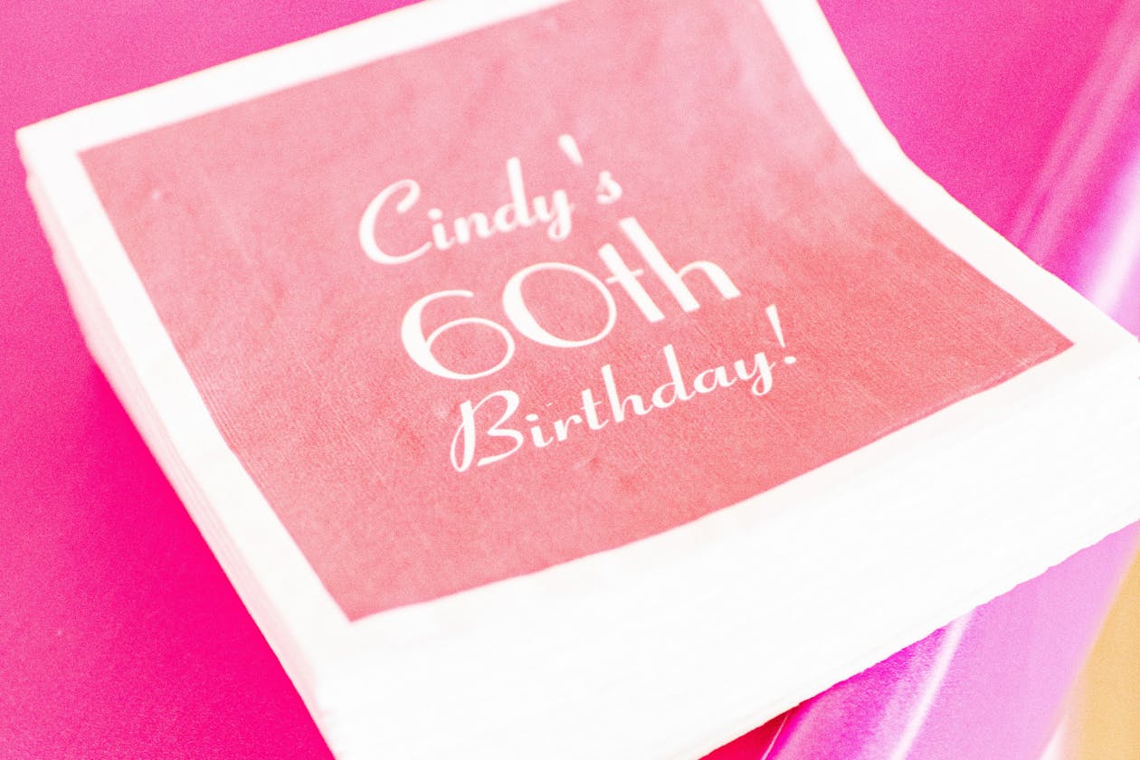 personalized 60th birthday napkins in pink | PartySlate