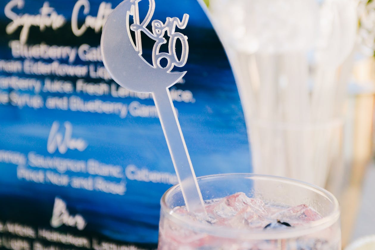 60th birthday party cocktails with personalized cocktail stirrers | PartySlate