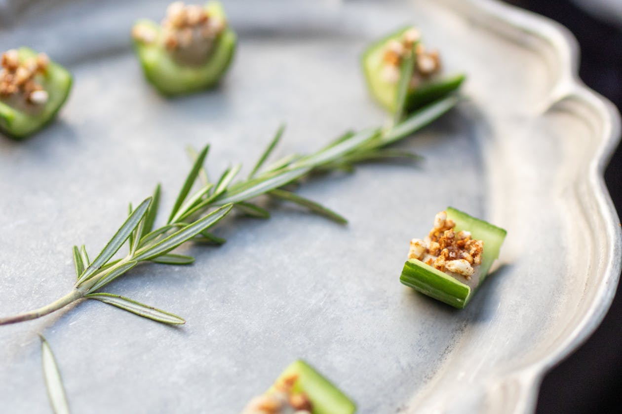 small cucumber appetizer on a silver tray | PartySlate