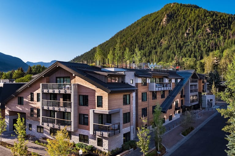 exterior photo of W Aspen with rooftop terrace overlooking mountains | PartySlate