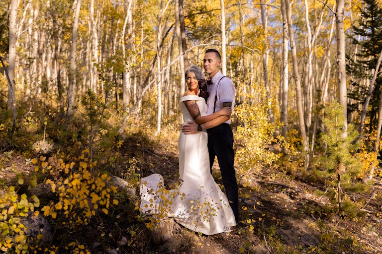 couple standing outside at colorado mountain wedding venue in fall | PartySlate