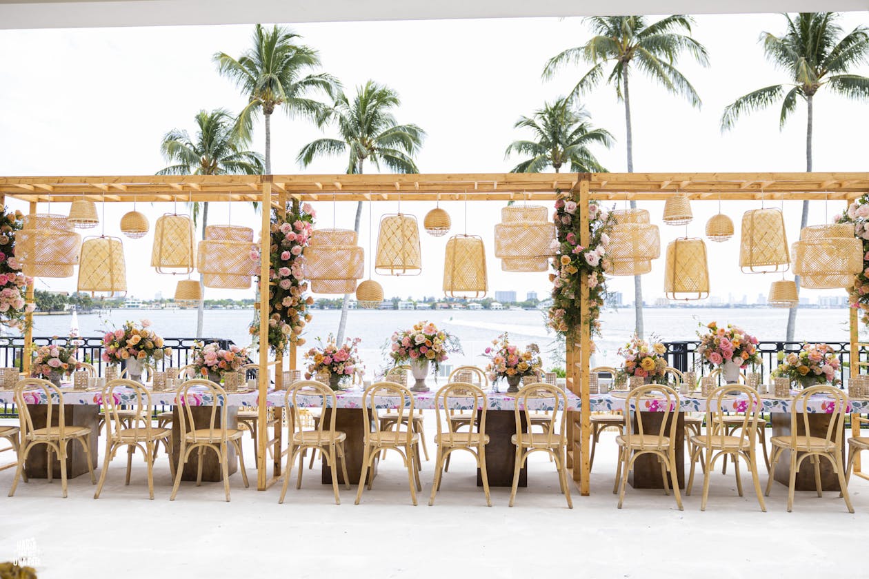 Boho wedding shower theme with suspended wicker baskets over king's table | PartySlate