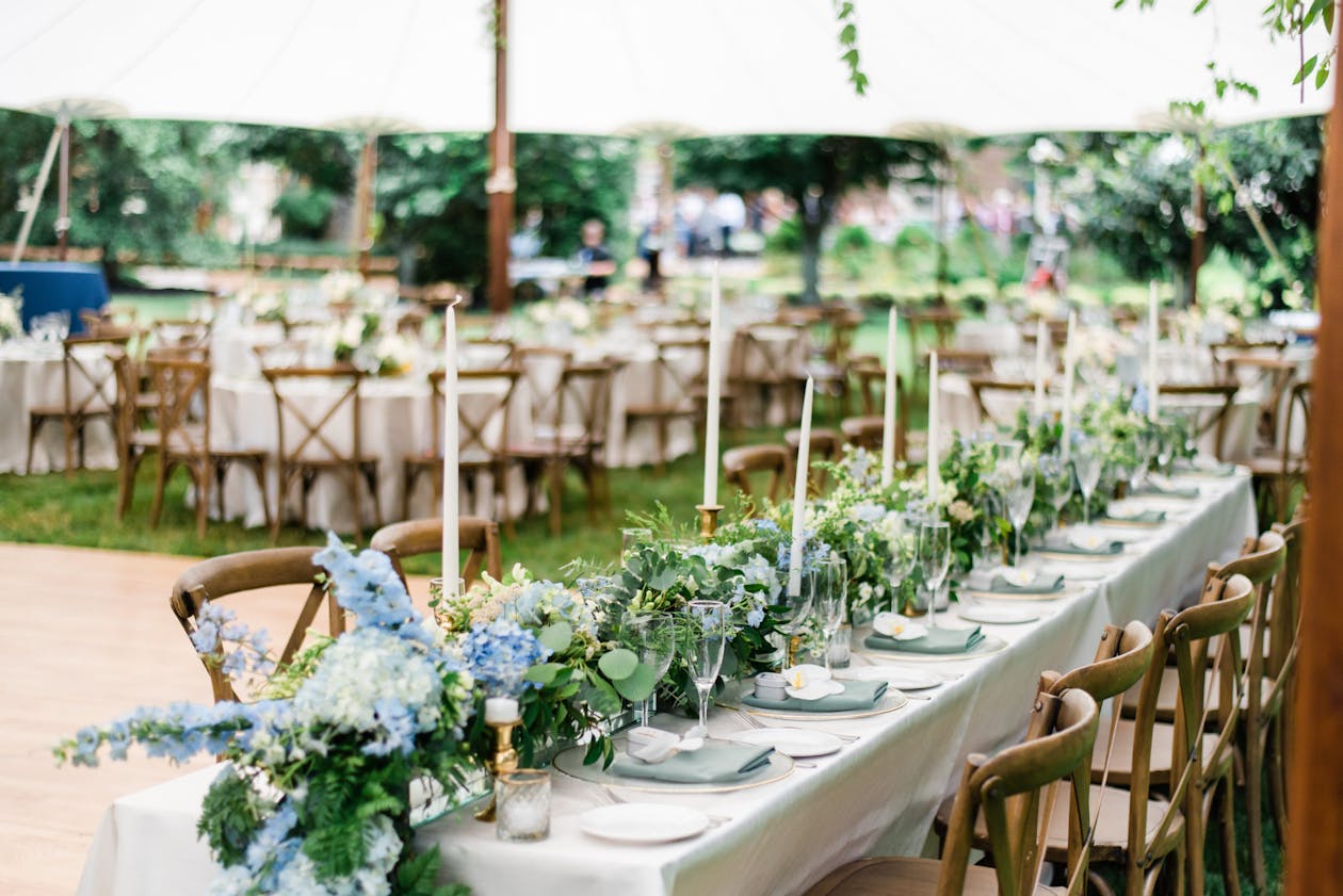 Outdoor summer wedding with blue floral centerpieces | PartySlate