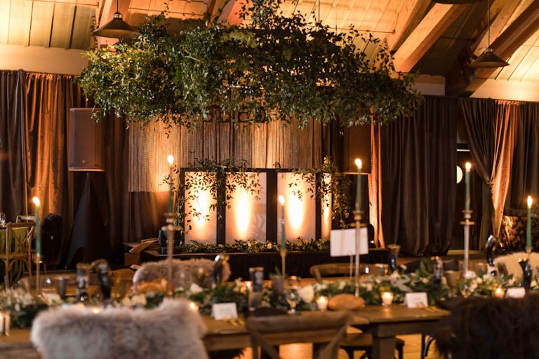Viking themed wedding at a colorado mountain wedding venue inside with greenery and soft lighting | PartySlate