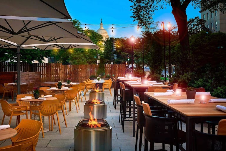 Art and Soul outdoor patio for private dining in dc with fire pits and a view of the capitol | PartySlate