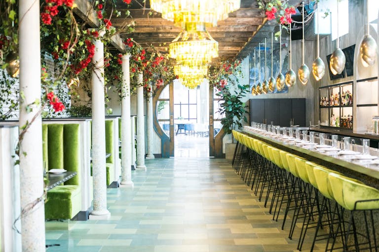 La Vie private dining in dc with florals inside the restaurant and a door leading to a private room | PartySlate