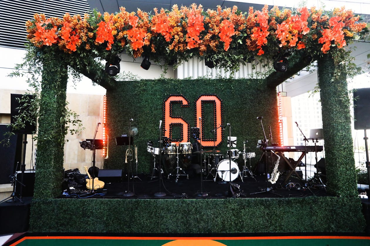baseball themed 60th birthday with 60 sign on stage | PartySlate