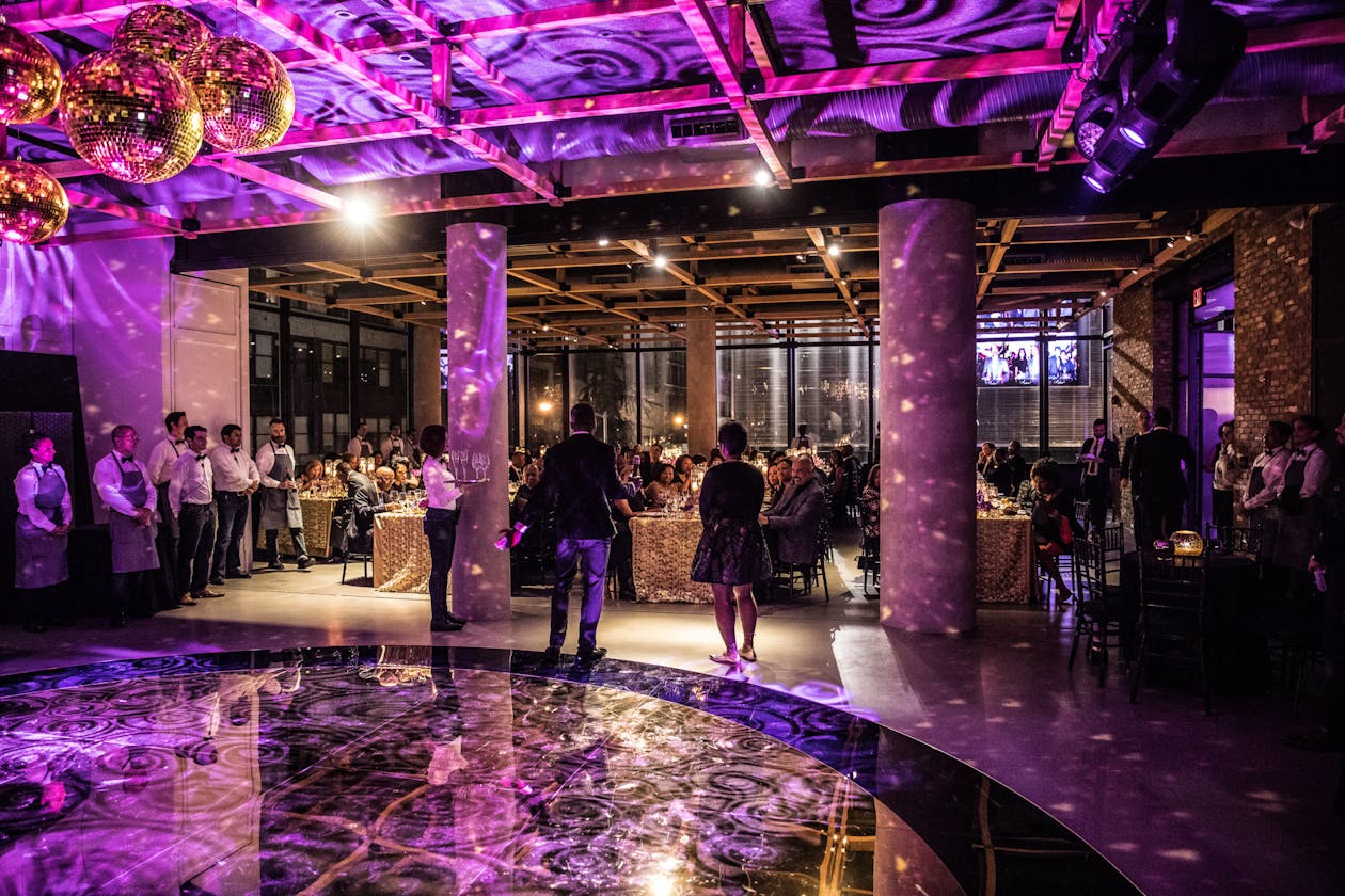 purple lighting on dance floor at 60th birthday party | PartySlate
