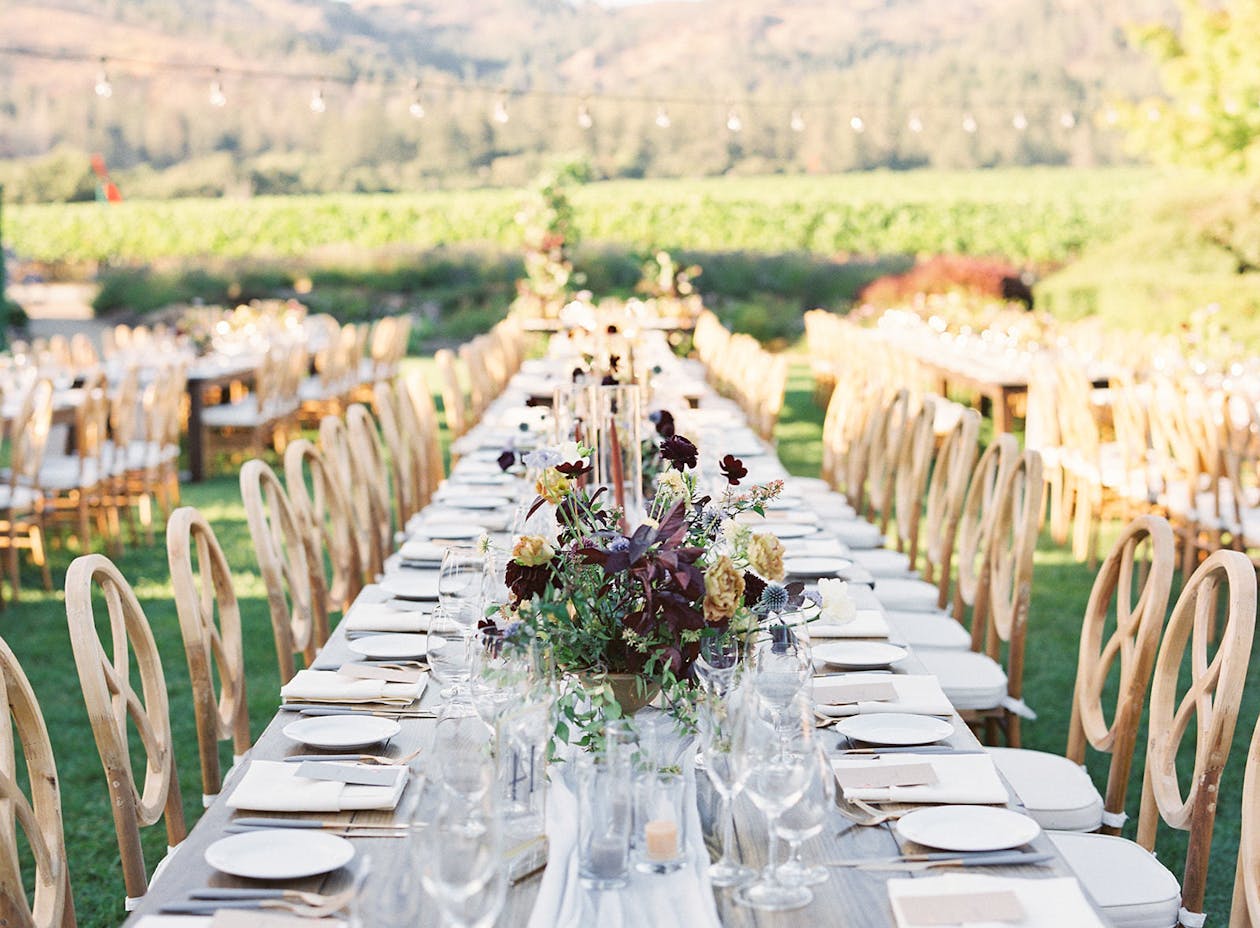 Summer wedding with burgundy wildflower centerpieces | PartySlate