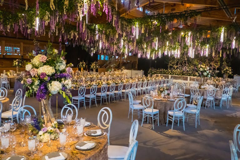 wedding at chapparal ranch in aspen colorado with purple and white floral ceiling decor | PartySlate