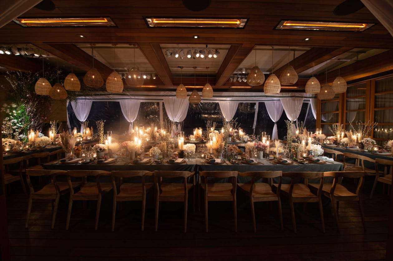 long king table at 60th birthday dinner party with moody lighting | PartySlate